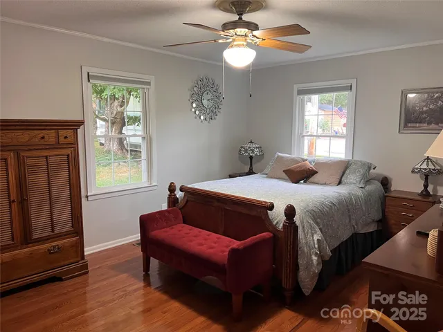 a bedroom with a bed dresser and a window
