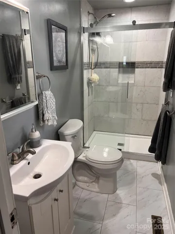 a bathroom with a toilet sink and shower