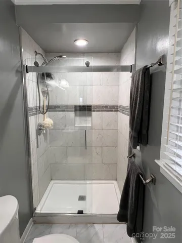 a bathroom with a shower and a tub