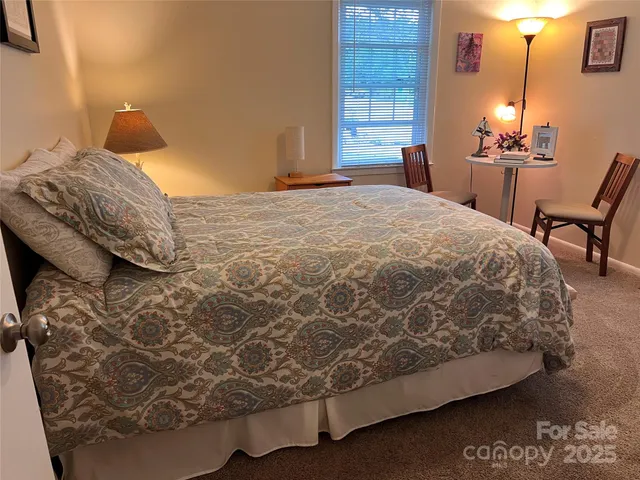 a bedroom with a bed and chair