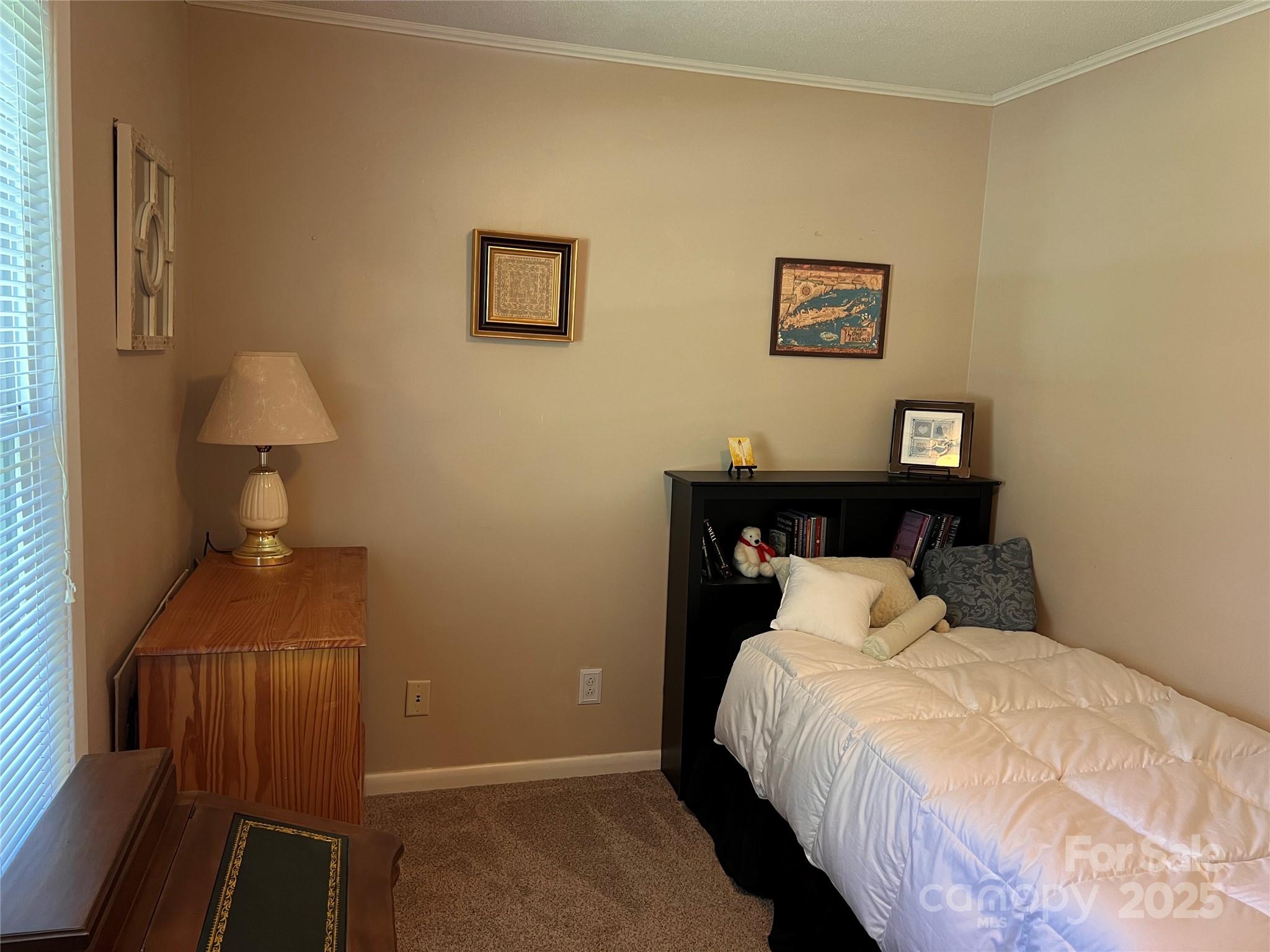 38430 Airport Road Albemarle, NC 28001 - Photo 34 of 39 a bedroom with a bed and a lamp on table