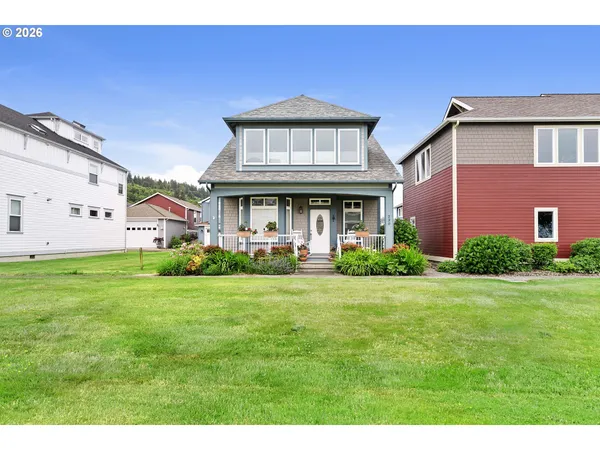 a view of a big house with a big yard and large trees