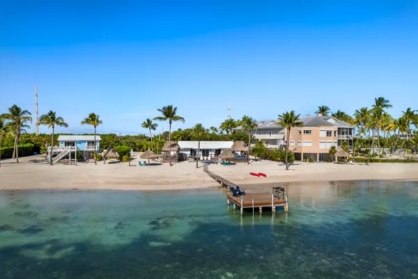 a chair and table sitting in the middle of a lake