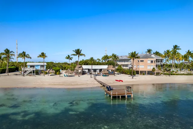 a chair and table sitting in the middle of a lake