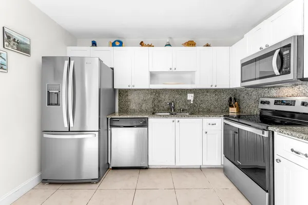 a view of a house with a patio and a yard