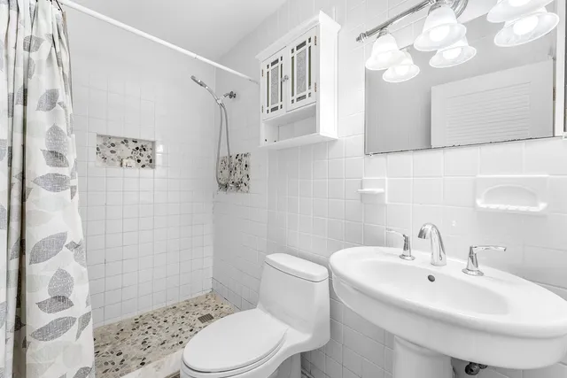 a living room with furniture a rug and a bookshelf