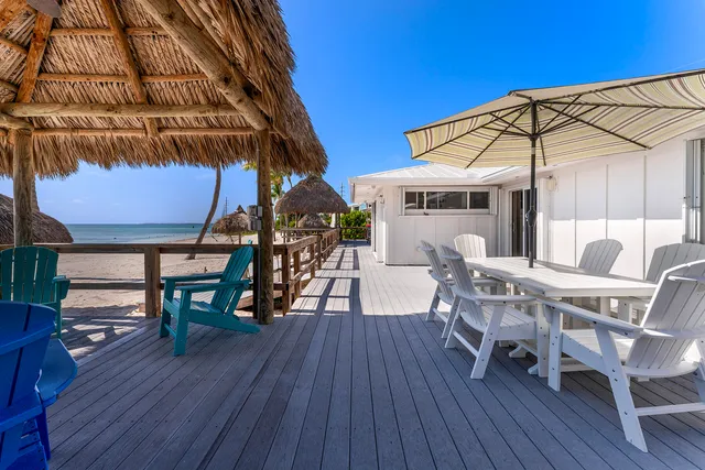 a kitchen with stainless steel appliances granite countertop a refrigerator stove a sink and dishwasher with white cabinets