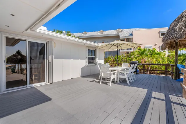 a kitchen with stainless steel appliances a refrigerator sink and white cabinets