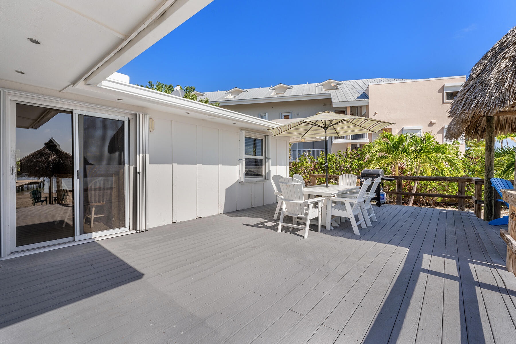 65620 Overseas Highway Long Key, FL 33001 - Photo 36 of 65 a view of a patio with table and chairs with wooden floor and fence