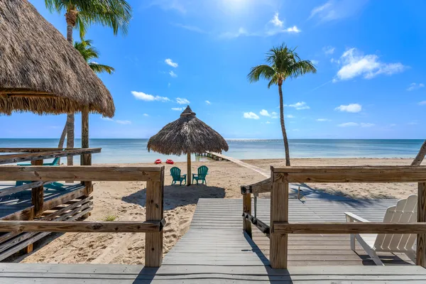 a bedroom with a bed a dresser and next to a window