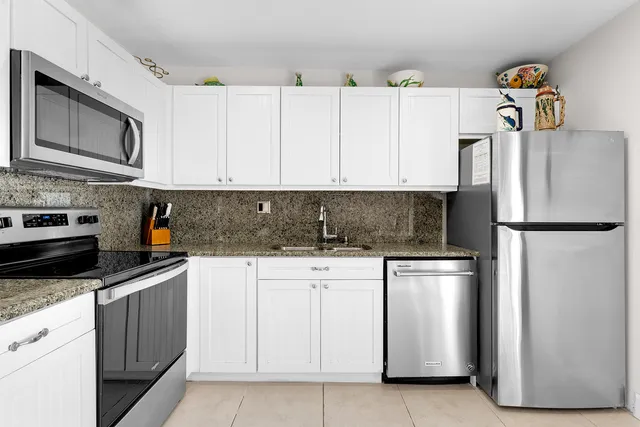 a patio with wooden floor table and chairs