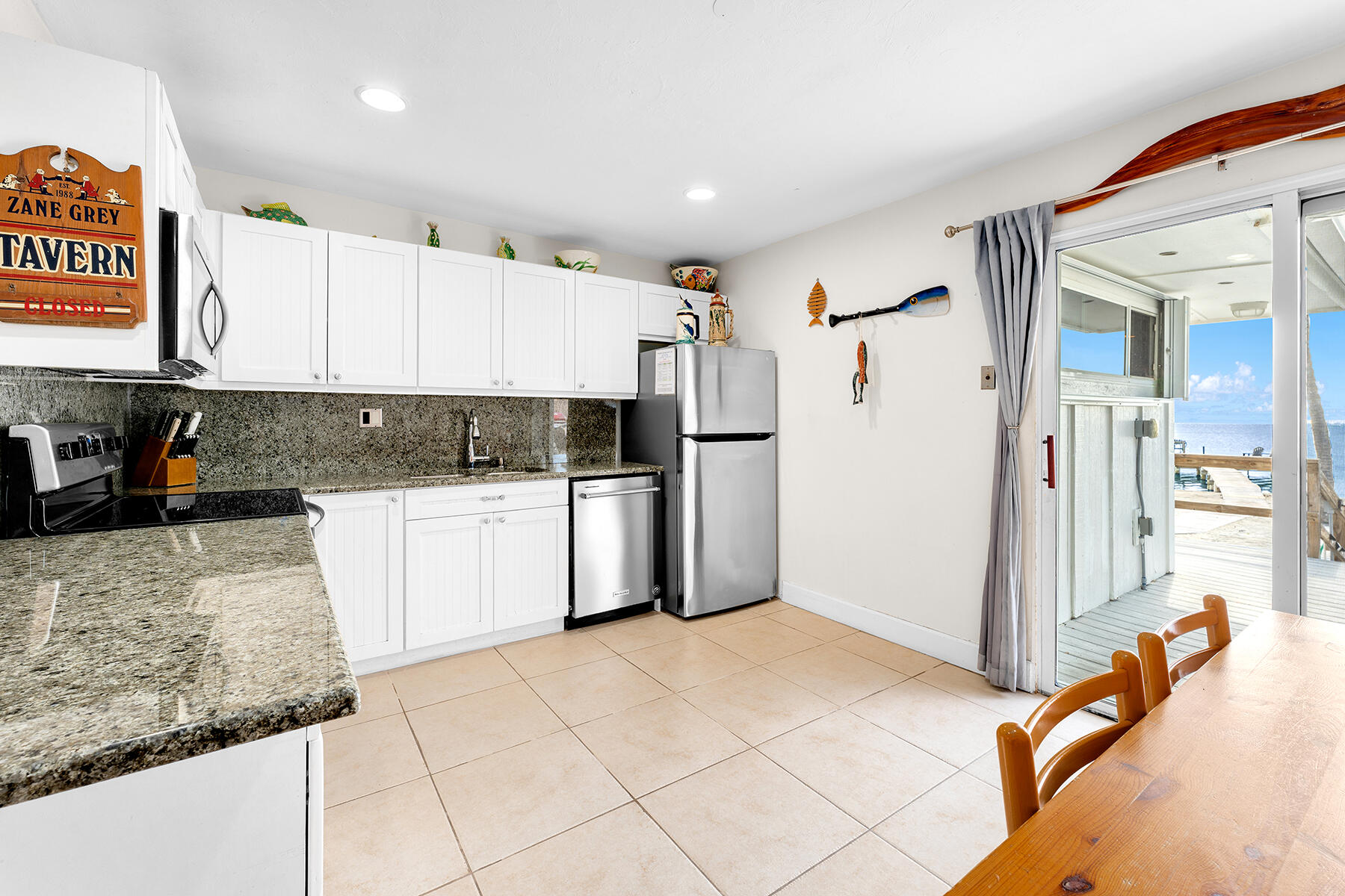 65620 Overseas Highway Long Key, FL 33001 - Photo 44 of 65 a kitchen with stainless steel appliances granite countertop a refrigerator sink and white cabinets