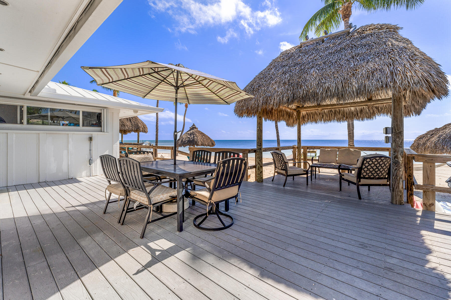 65620 Overseas Highway Long Key, FL 33001 - Photo 51 of 65 a view of patio with table and chairs under an umbrella with wooden floor