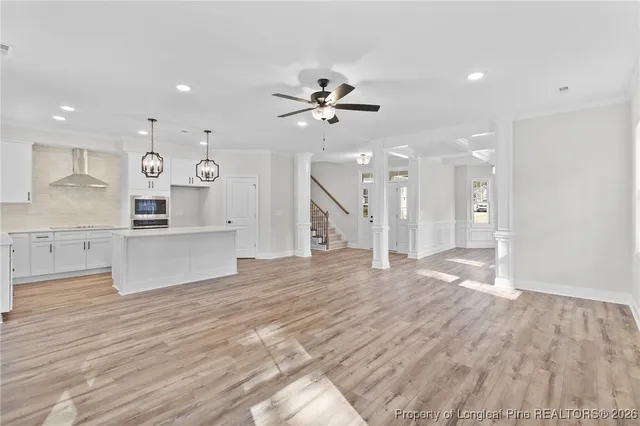 a view of kitchen and hall with wooden floor