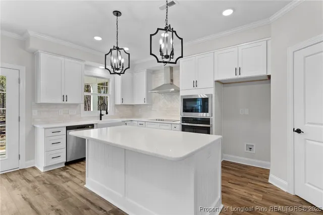 a kitchen with cabinets a sink and stainless steel appliances