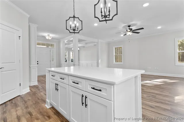 a view of a kitchen counter space a sink and chandelier