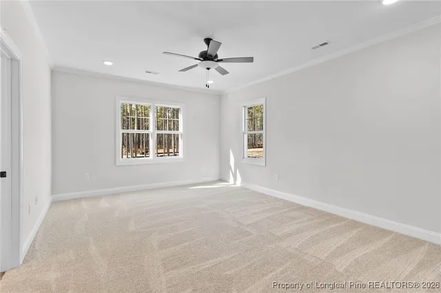 a view of an empty room with a ceiling fan