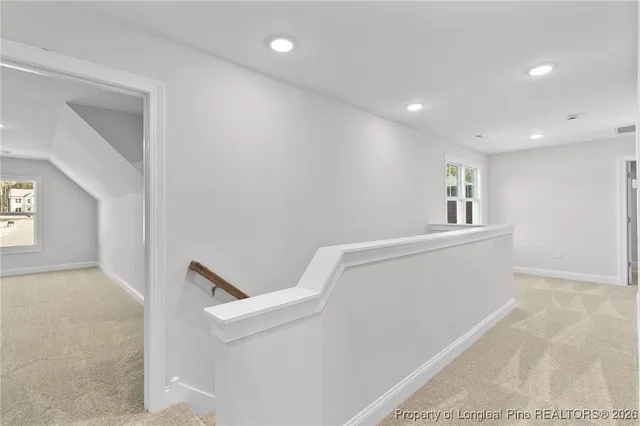 a view of an empty room with a ceiling fan
