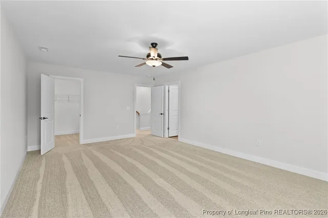 a spacious bathroom with a double vanity sink a mirror and a