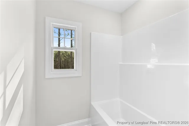 a backyard of a house with basket ball court and floor to ceiling window