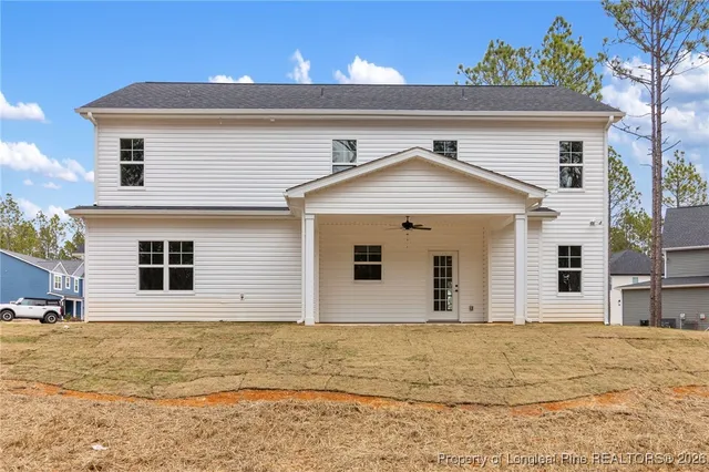 a view of a white house with a yard