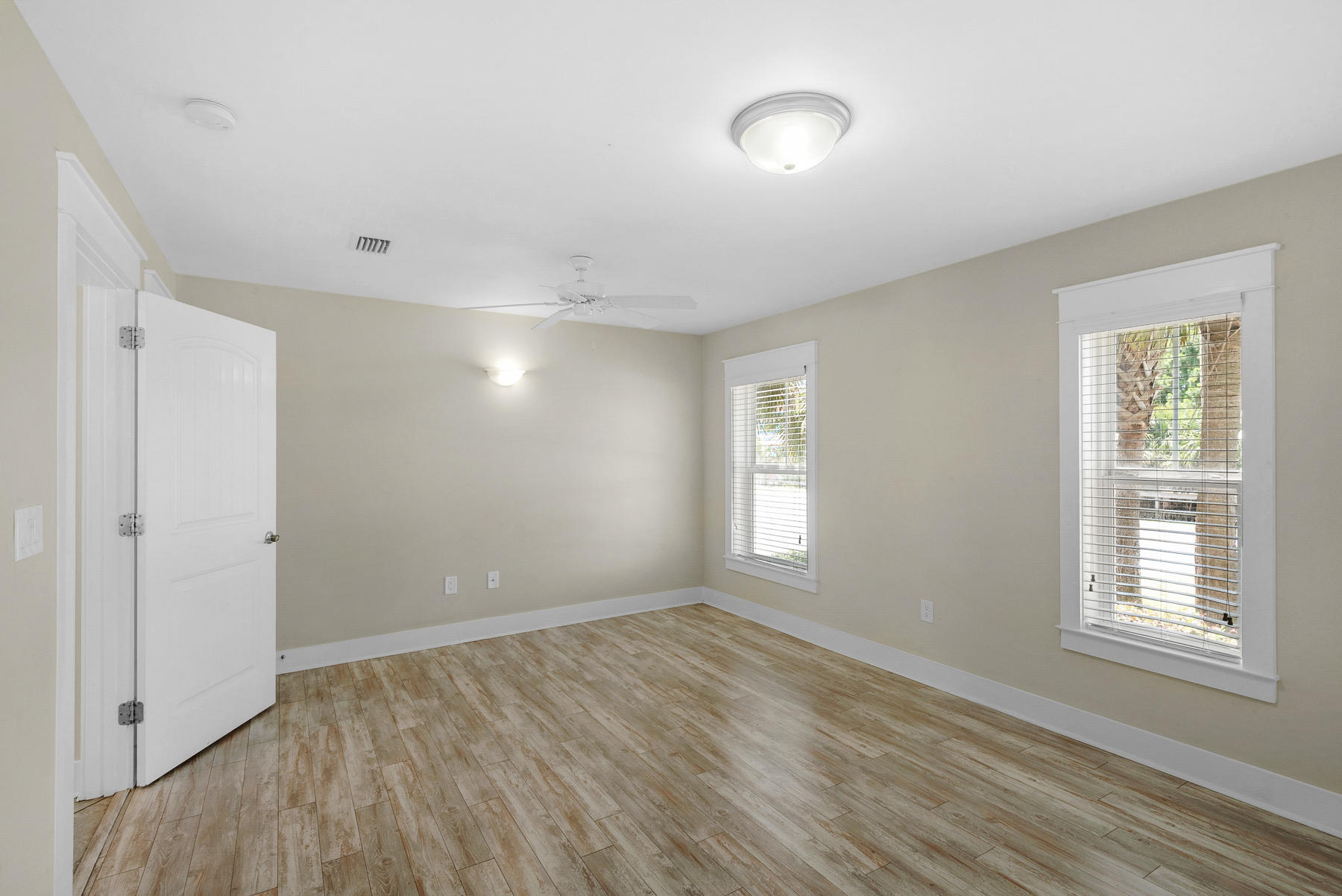 7 Seaspring Cove Santa Rosa Beach, FL 32459 - Photo 11 of 46 a view of an empty room with wooden floor and a window