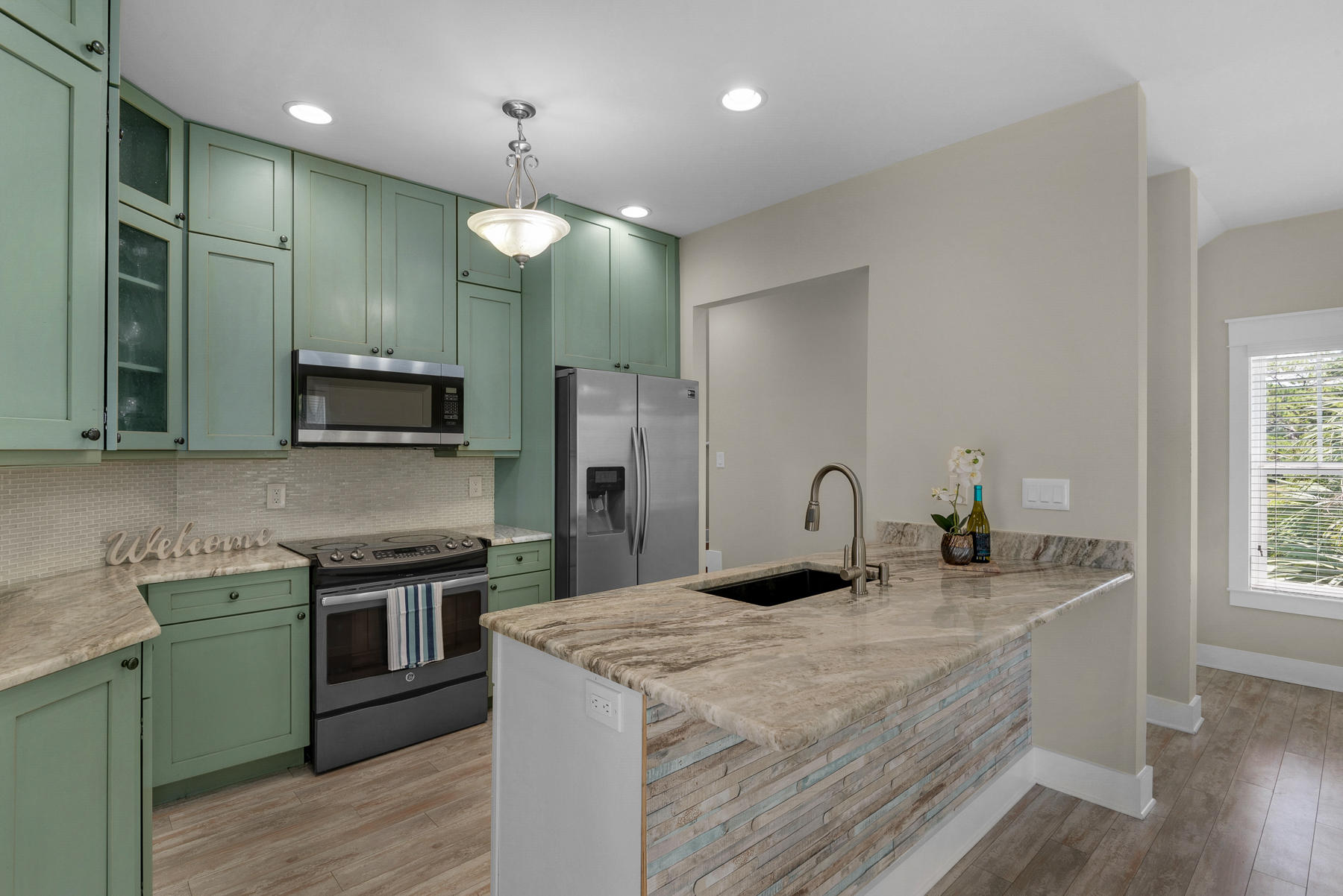 7 Seaspring Cove Santa Rosa Beach, FL 32459 - Photo 19 of 46 a kitchen with kitchen island a sink stainless steel appliances and cabinets