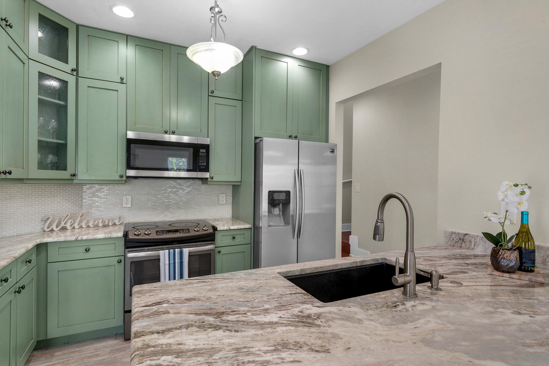 7 Seaspring Cove Santa Rosa Beach, FL 32459 - Photo 21 of 46 a kitchen with a sink and a stove top oven