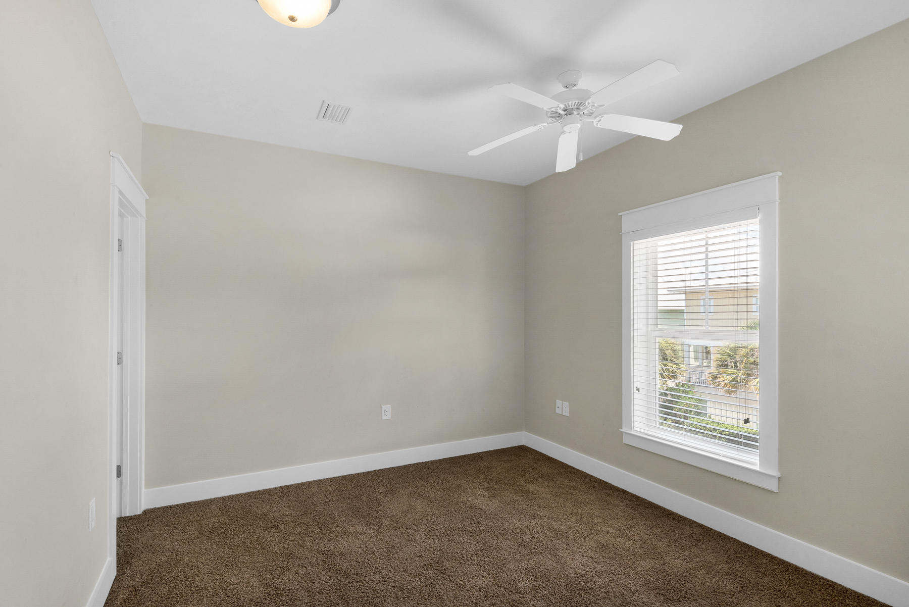 7 Seaspring Cove Santa Rosa Beach, FL 32459 - Photo 41 of 46 an empty room with a window and a fan