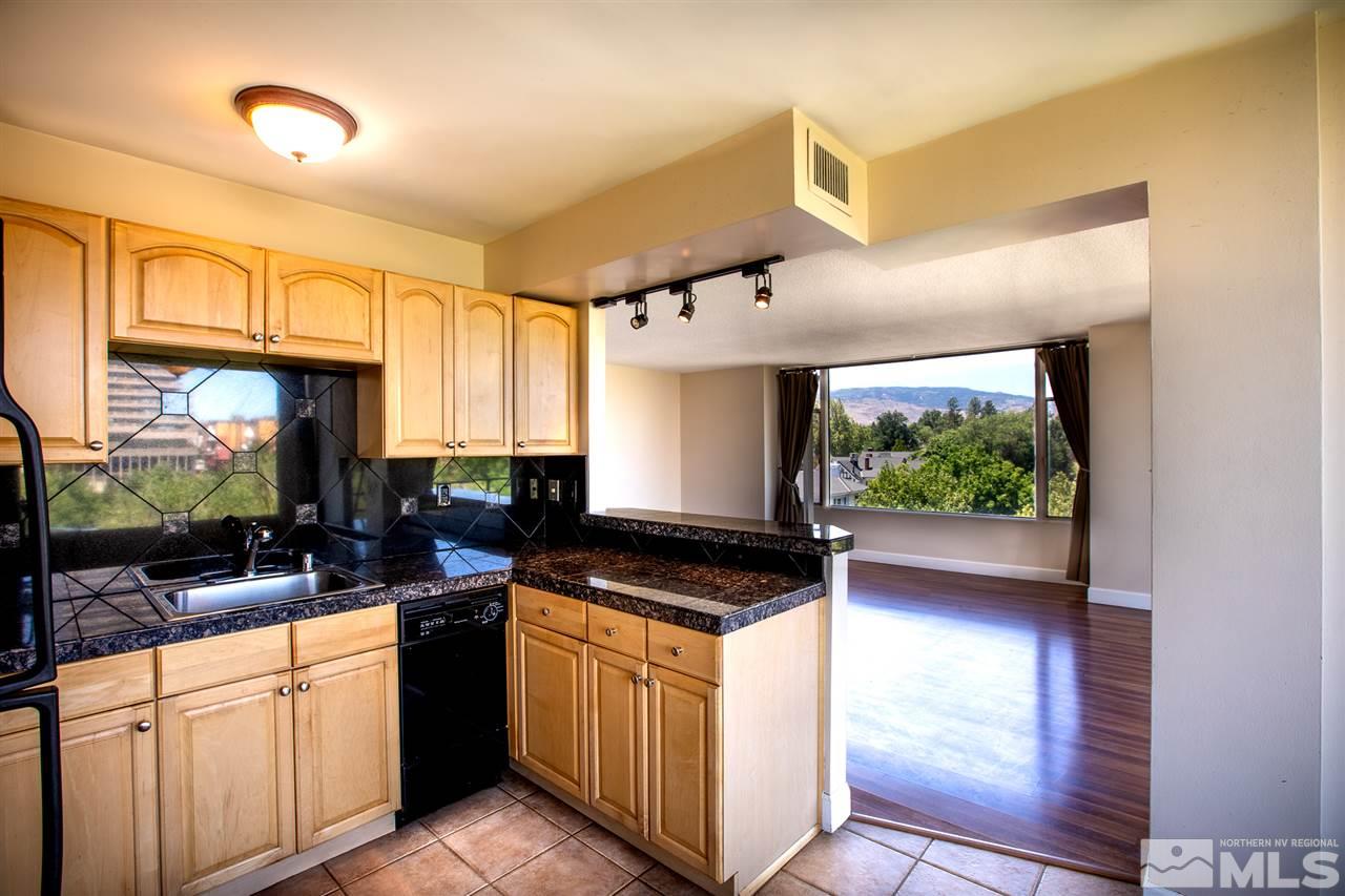 280 Island, Unit 703 Reno, NV 89501 - Photo 12 of 34 a kitchen with stainless steel appliances granite countertop a stove a sink and a microwave