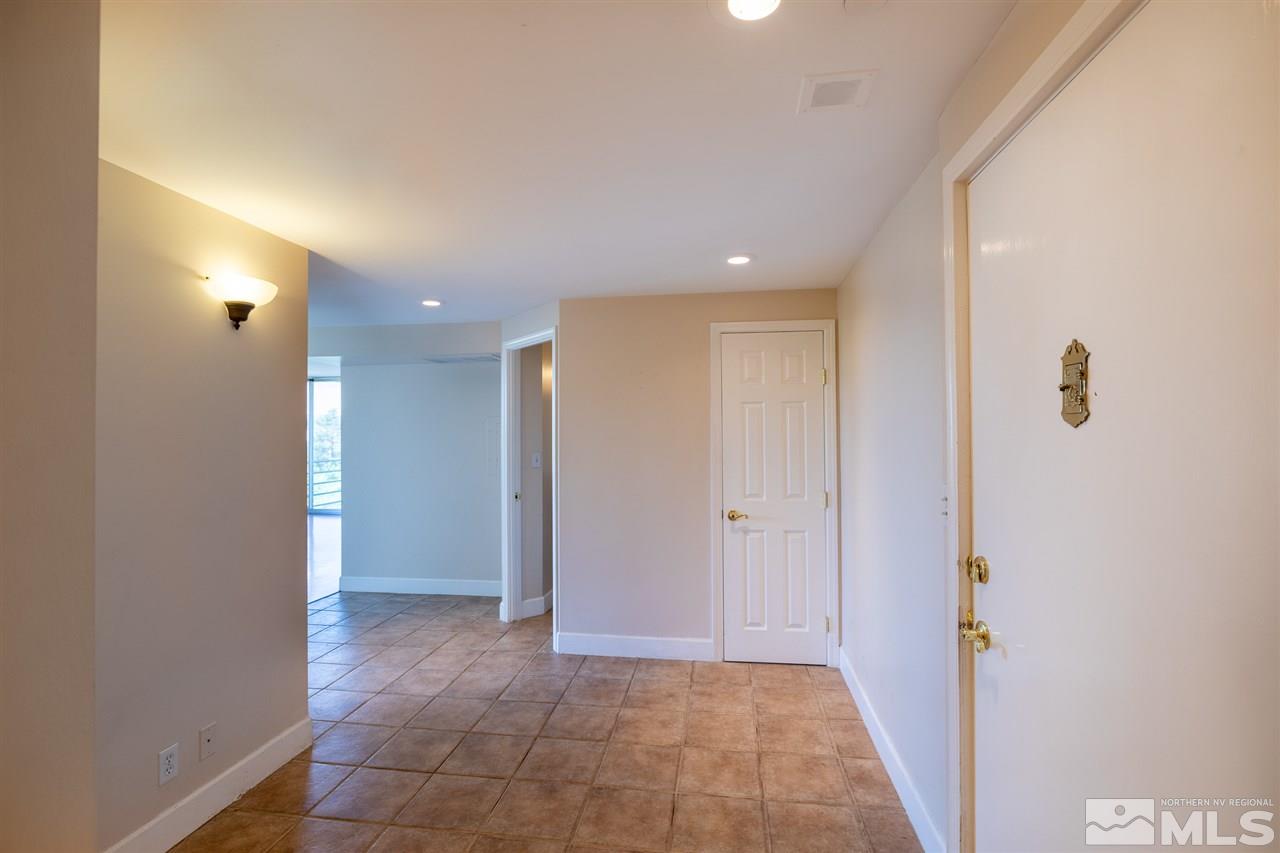 280 Island, Unit 703 Reno, NV 89501 - Photo 21 of 34 a view of hallway with a rug and a window