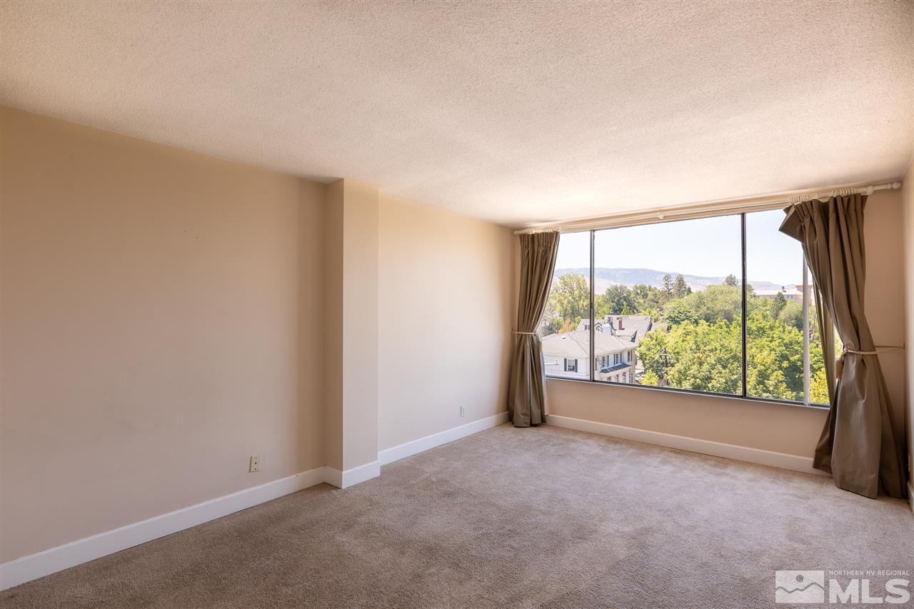 280 Island, Unit 703 Reno, NV 89501 - Photo 24 of 34 an empty room with large windows and view of balcony