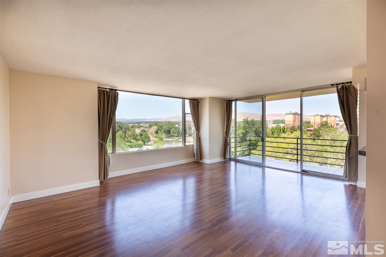 280 Island, Unit 703 Reno, NV 89501 - Photo 6 of 34 wooden floor in an empty room with a window