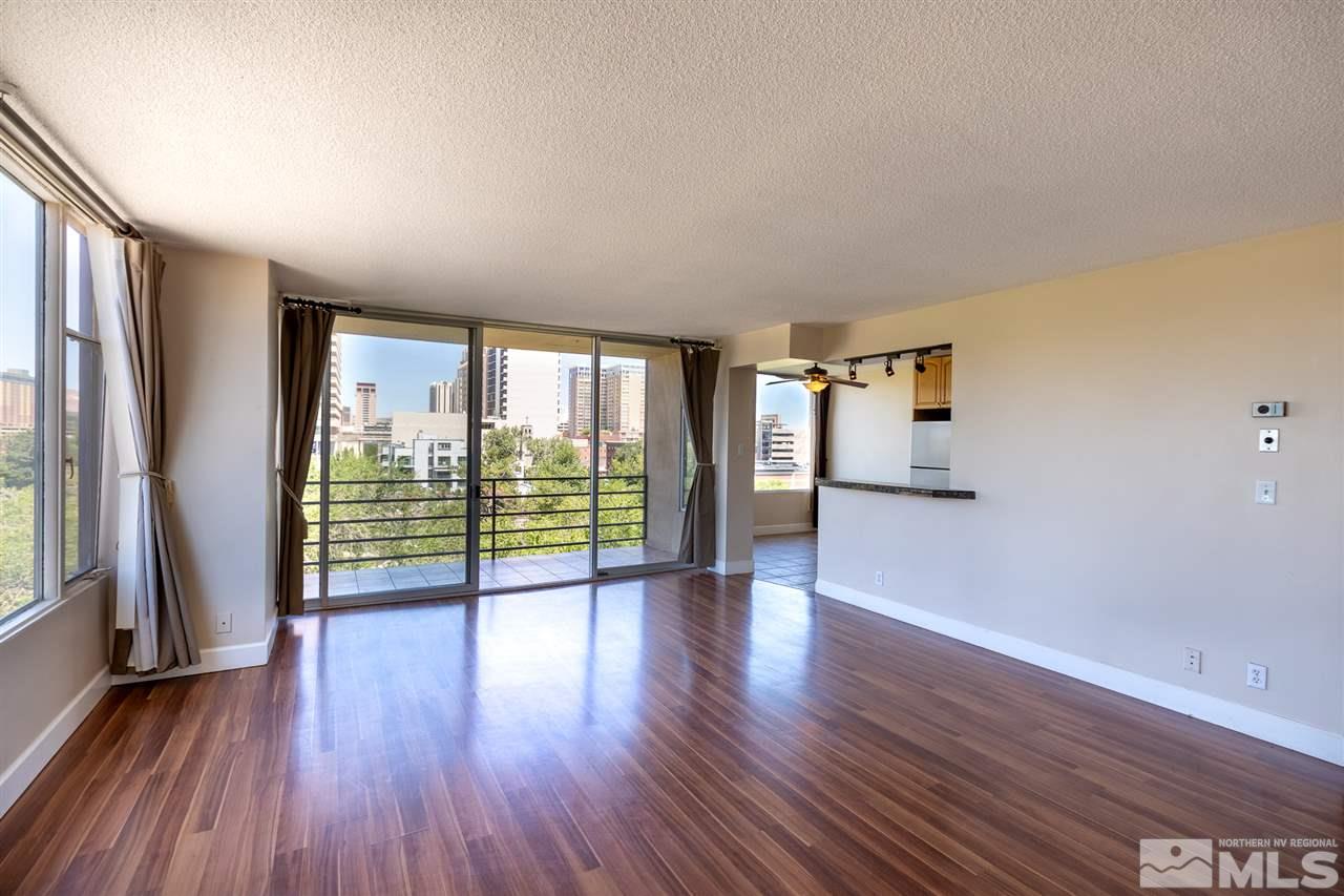 280 Island, Unit 703 Reno, NV 89501 - Photo 7 of 34 an empty room with wooden floor and windows