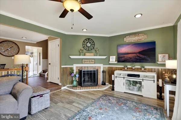 a living room with furniture flat screen tv and a fireplace