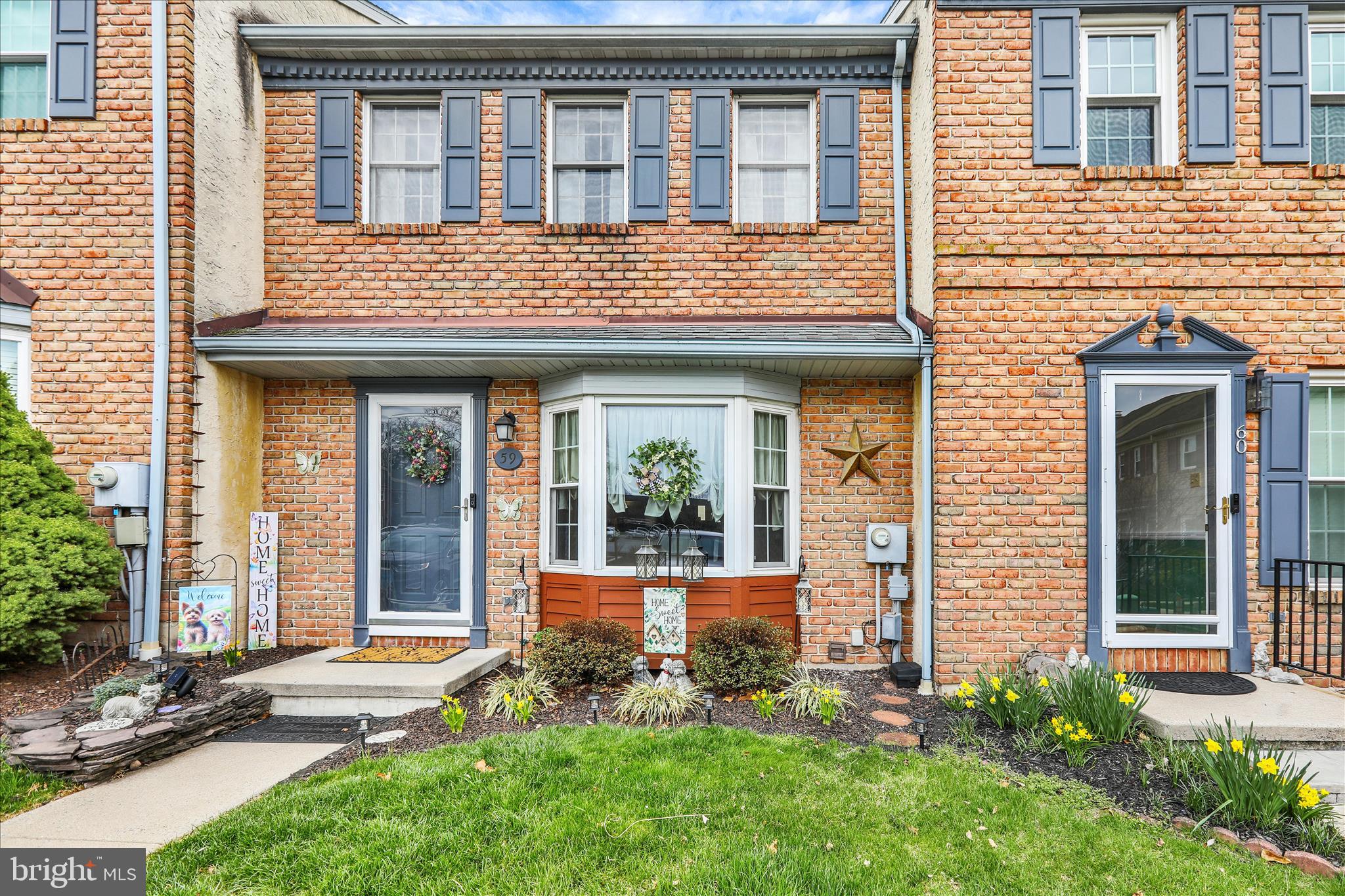 59 Winchester Court Reading, PA 19606 - Photo 2 of 39 a view of brick house with a large windows and plants