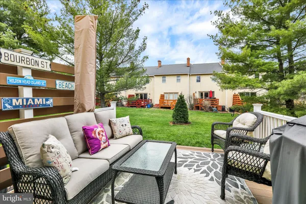 a view of a house with a backyard and a patio