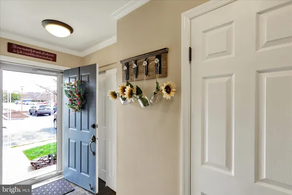 a view of a porch with a refrigerator and a window