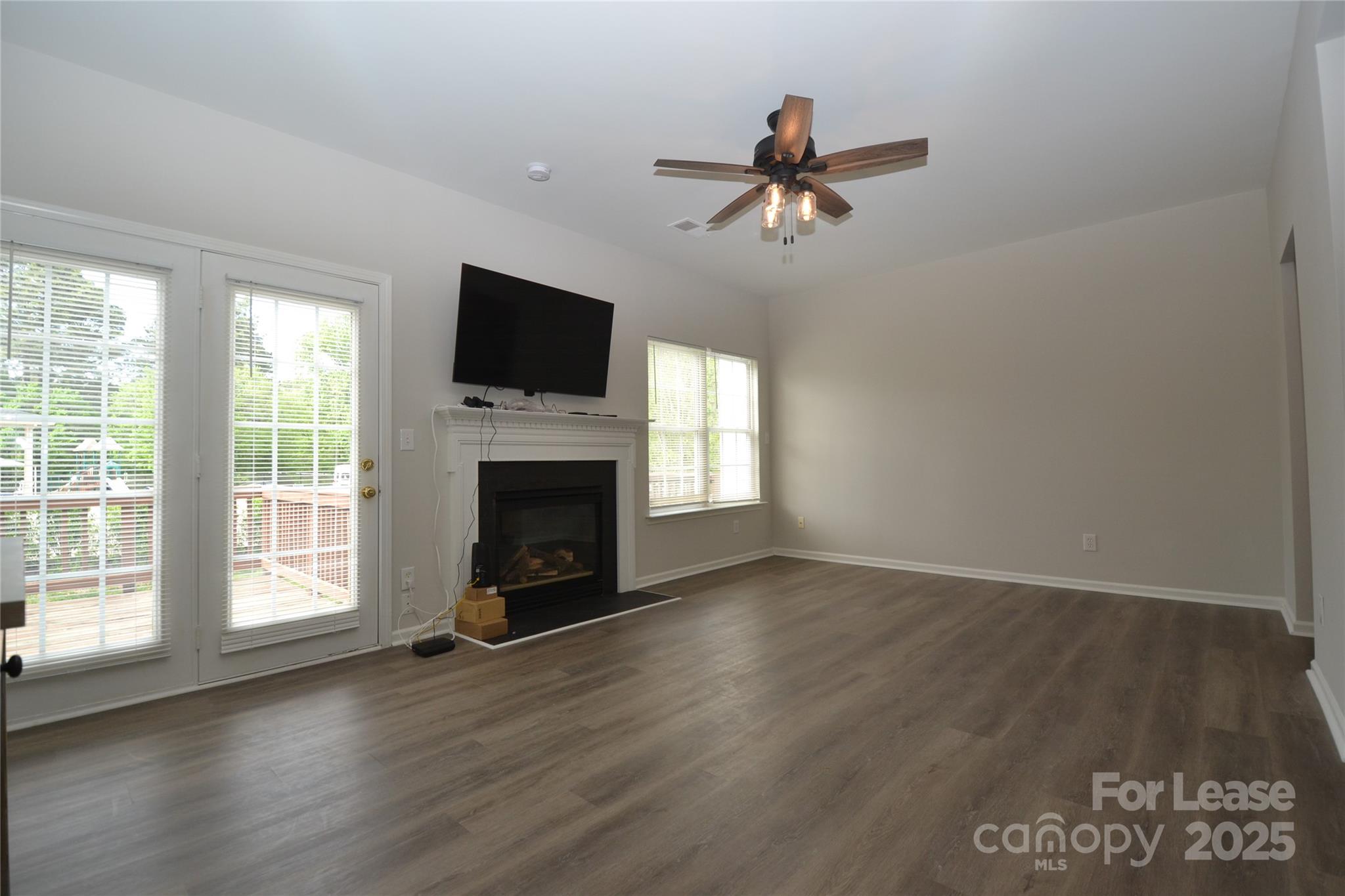 9647 Bailey Road Cornelius, NC 28031 - Photo 1 of 29 a view of a livingroom with a fireplace wooden floor and windows
