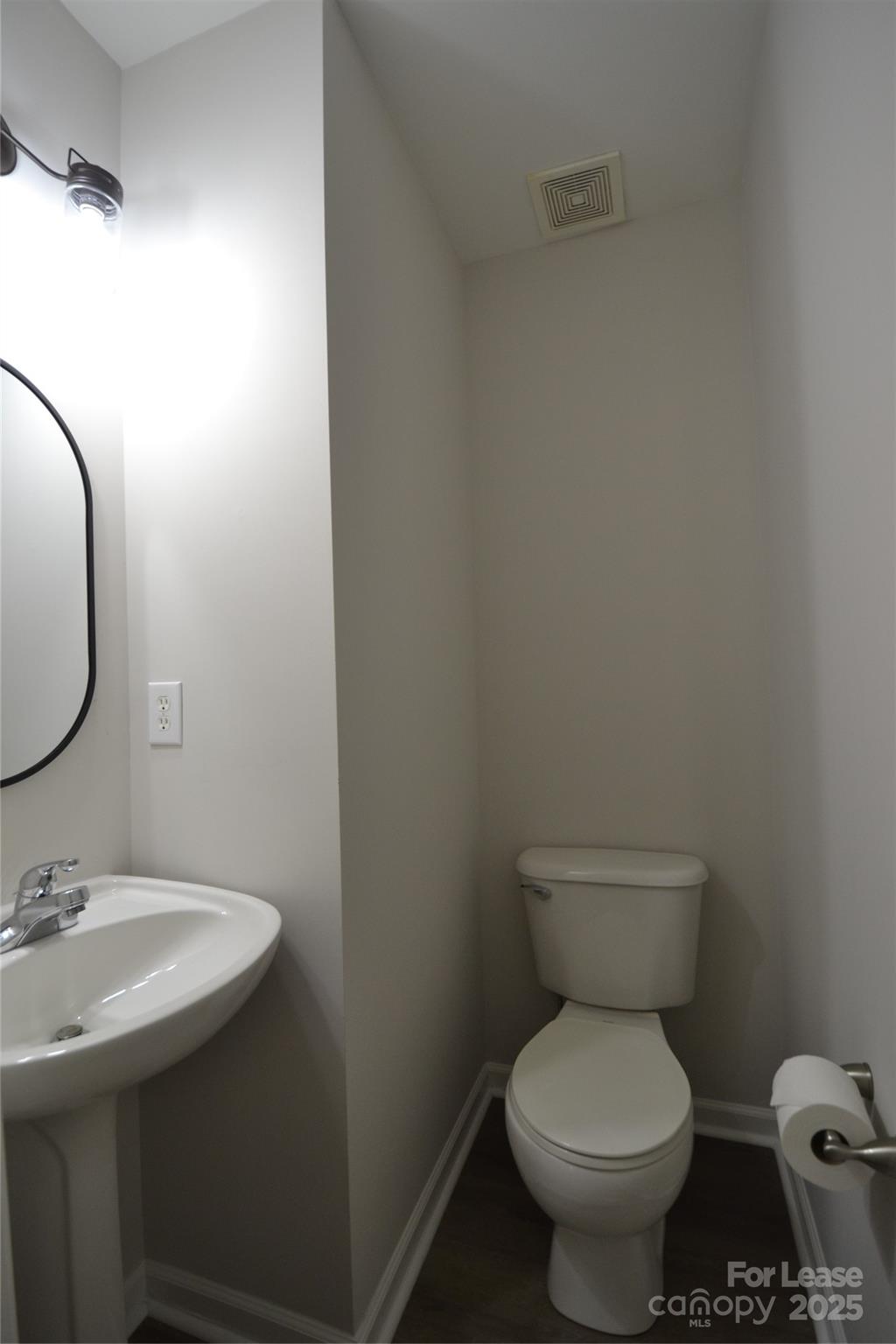 9647 Bailey Road Cornelius, NC 28031 - Photo 12 of 29 a white toilet sitting next to a bathroom sink