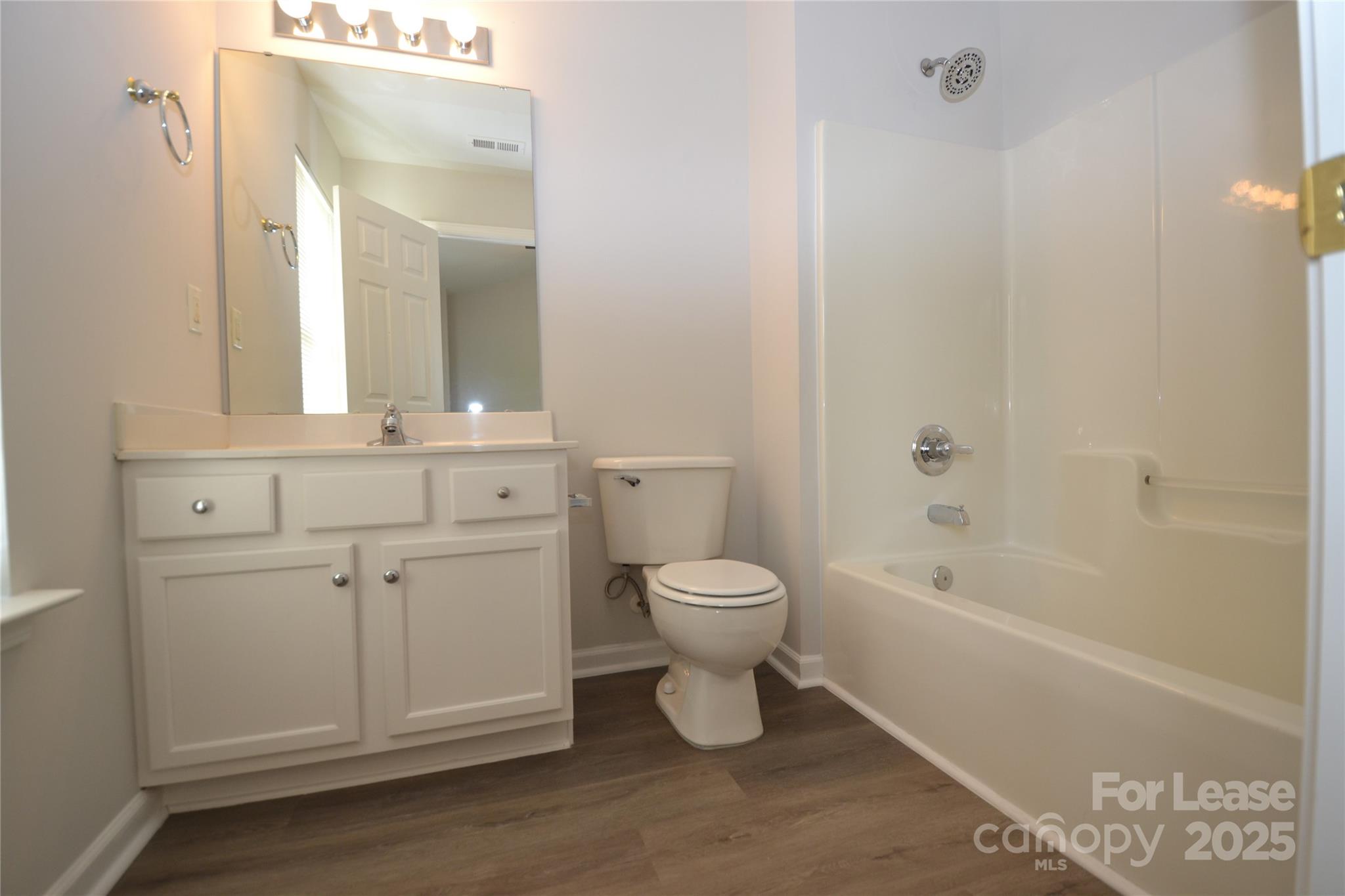 9647 Bailey Road Cornelius, NC 28031 - Photo 17 of 29 a bathroom with a toilet a sink and bathtub