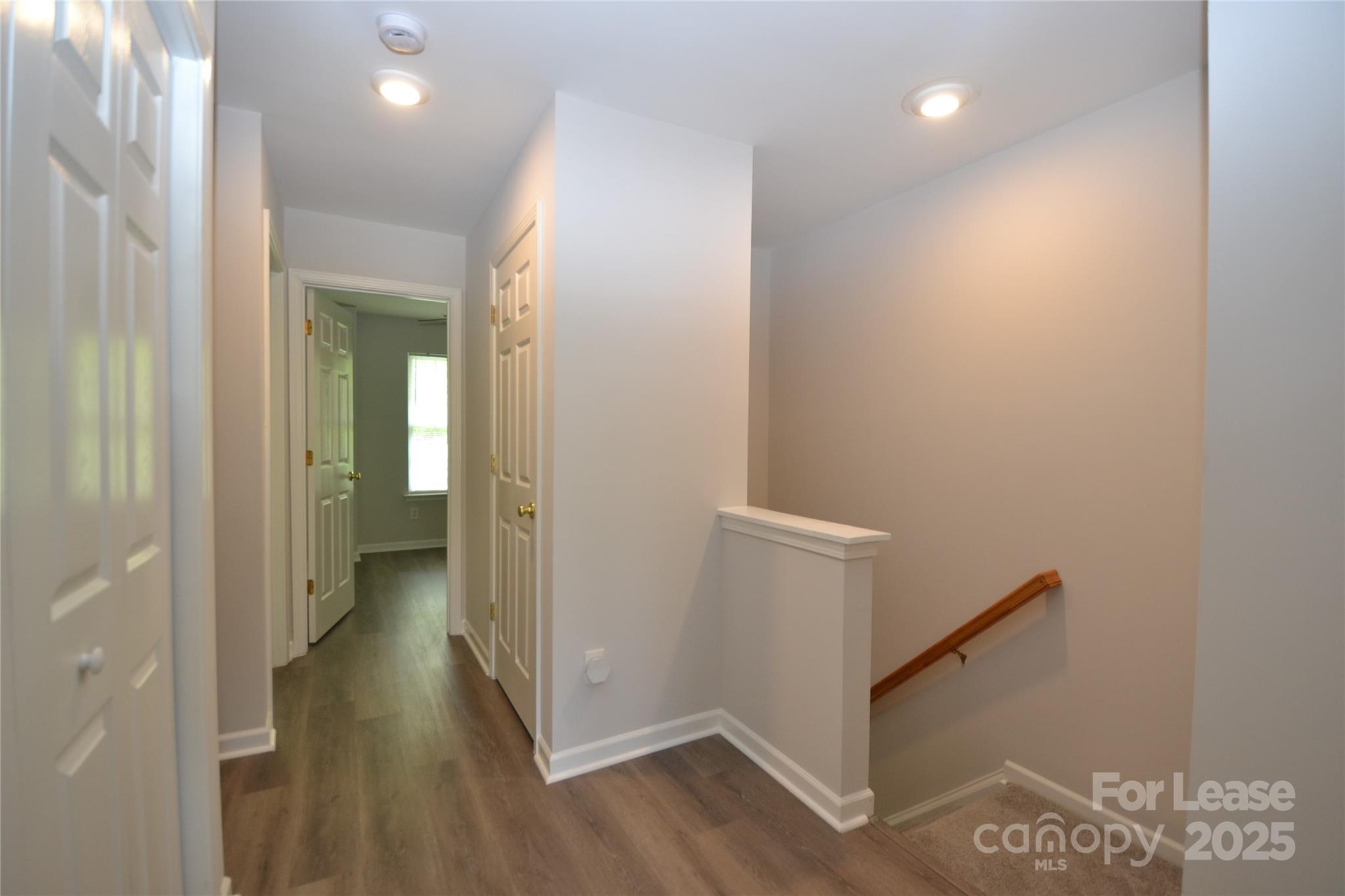 9647 Bailey Road Cornelius, NC 28031 - Photo 19 of 29 a view of a hallway with wooden floor