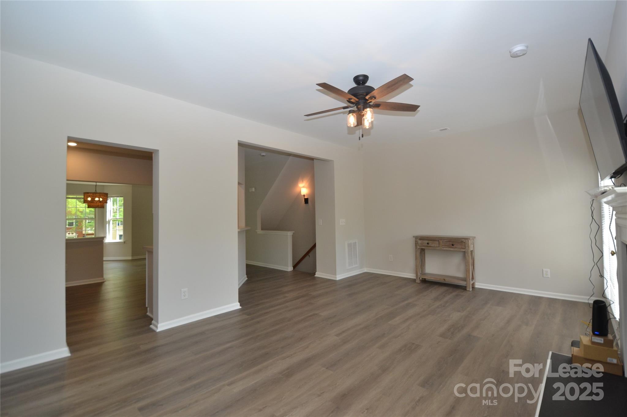 9647 Bailey Road Cornelius, NC 28031 - Photo 2 of 29 a view of an empty room and wooden floor