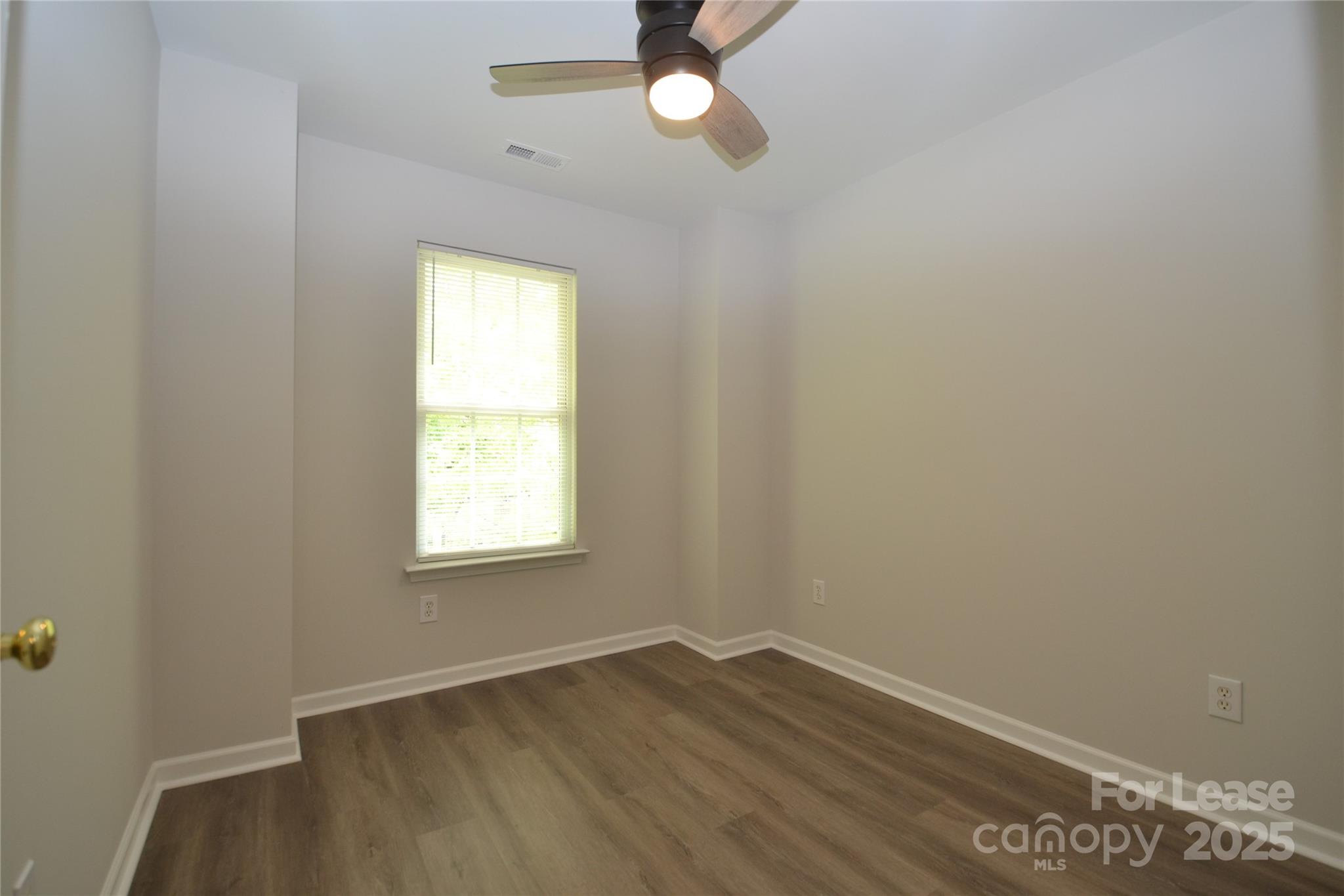 9647 Bailey Road Cornelius, NC 28031 - Photo 22 of 29 an empty room with wooden floor and windows