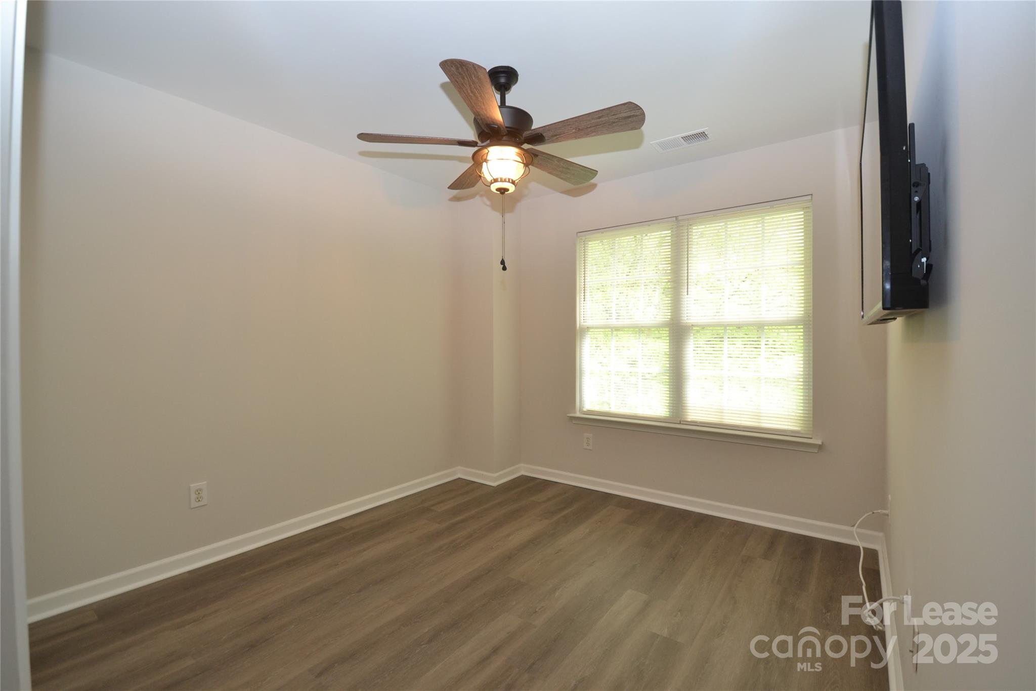 9647 Bailey Road Cornelius, NC 28031 - Photo 24 of 29 an empty room with wooden floor and windows