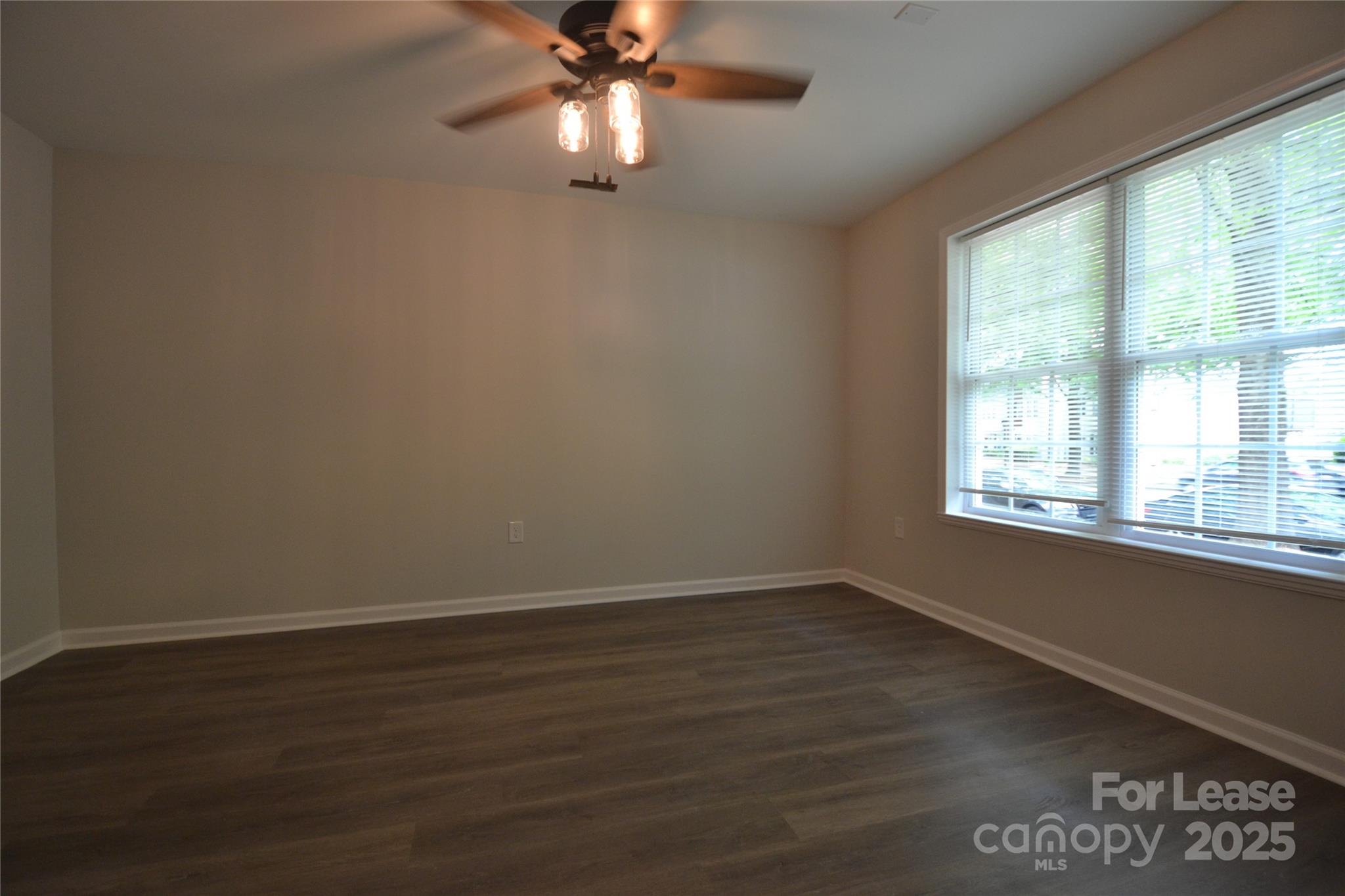 9647 Bailey Road Cornelius, NC 28031 - Photo 26 of 29 a view of an empty room with wooden floor and a window