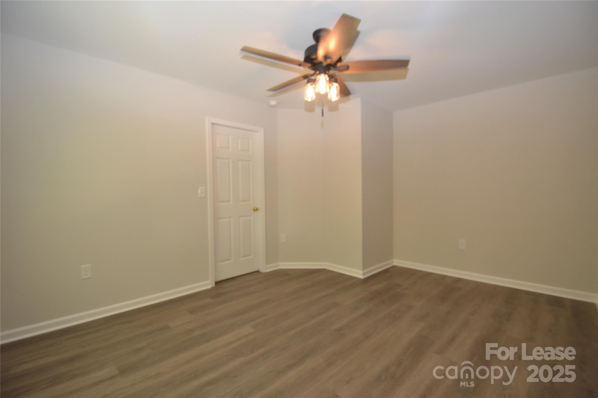9647 Bailey Road Cornelius, NC 28031 - Photo 28 of 29 a view of an empty room with wooden floor