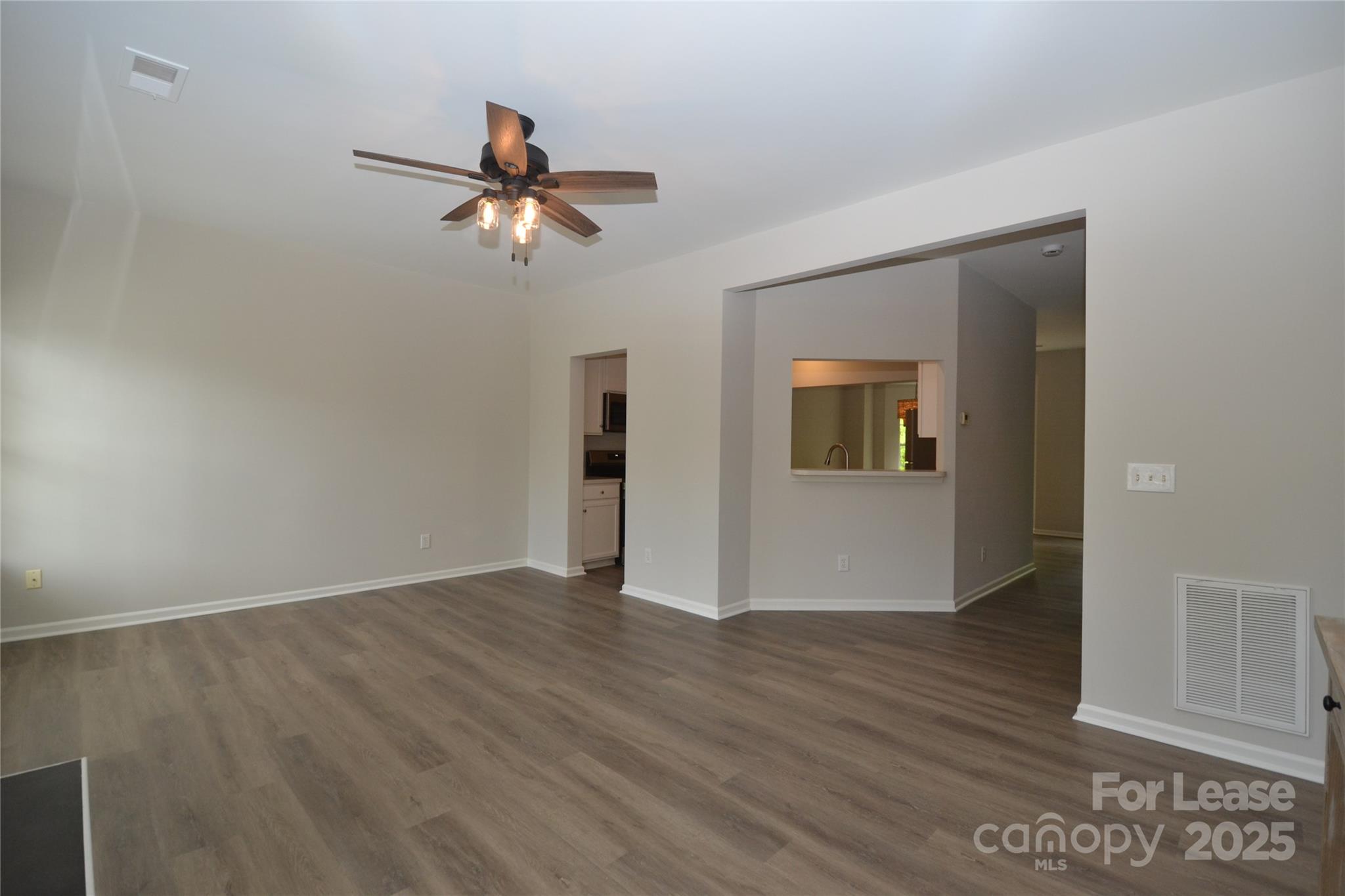 9647 Bailey Road Cornelius, NC 28031 - Photo 4 of 29 wooden floor in an empty room with a window