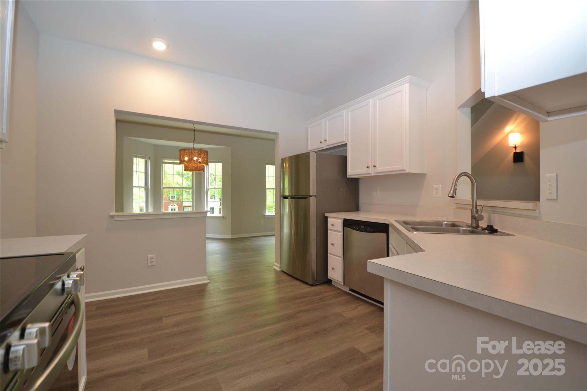 9647 Bailey Road Cornelius, NC 28031 - Photo 5 of 29 a kitchen with a refrigerator sink and cabinets