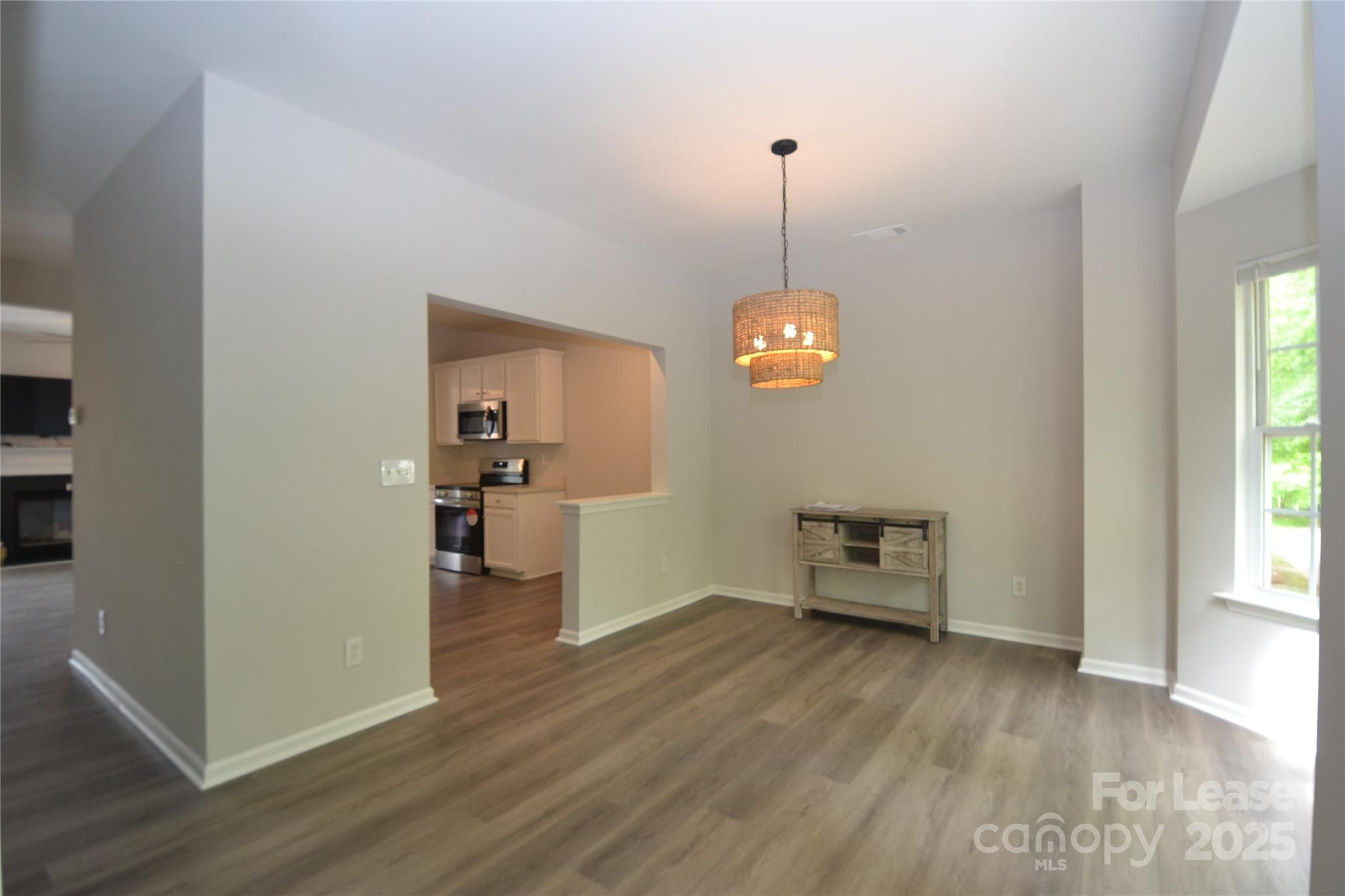 9647 Bailey Road Cornelius, NC 28031 - Photo 8 of 29 a view of a room wooden floor a ceiling fan and window